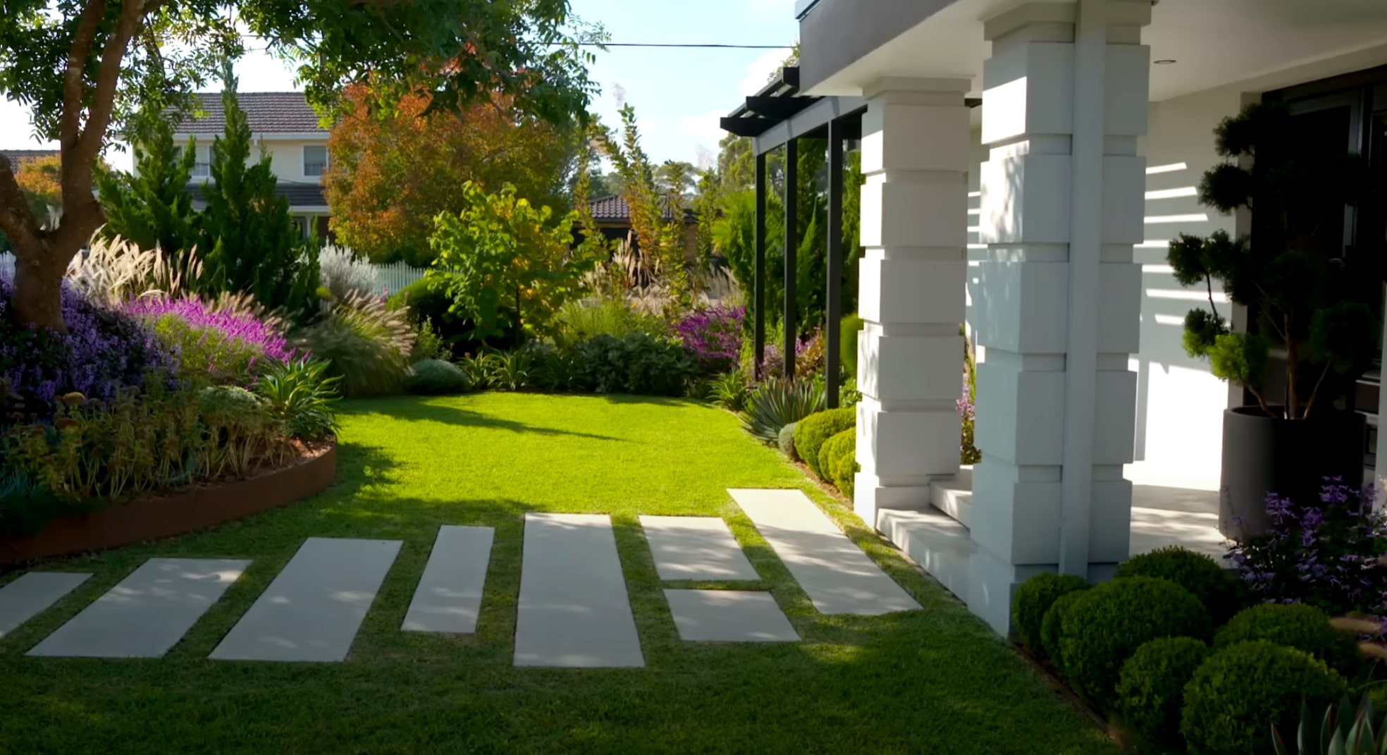 Contemporary Hardscaping - Stone Pathways and Garden Integration Modern front yard landscaping with geometric stone pathways and diverse plantings
